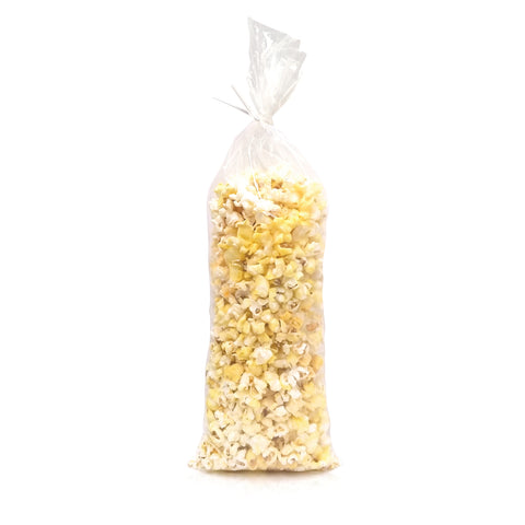 Clear plastic 16 inch poly bag filled with yellow popcorn isolated on a white background.