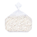 Bulk white cheddar popcorn packaged in a clear plastic bag with popped kernels visible.
