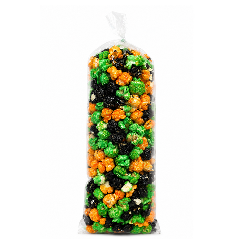 A clear plastic bag filled with Halloween-themed popcorn in green, orange, and black colors, isolated on a white background.