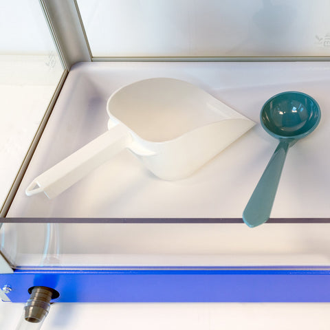 ice scoop and snow dipper pictured inside Sno-Kone machine 