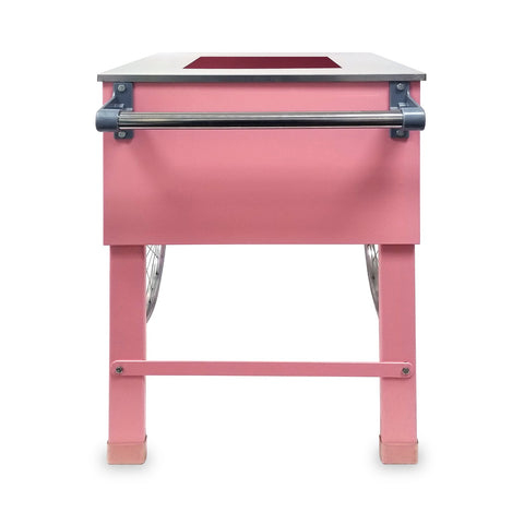 side view of handle on two-wheeled pink cotton candy cart