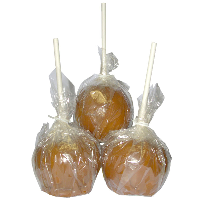 3 caramel apples on sticks wrapped by clear cello wrap, closed with twist ties.