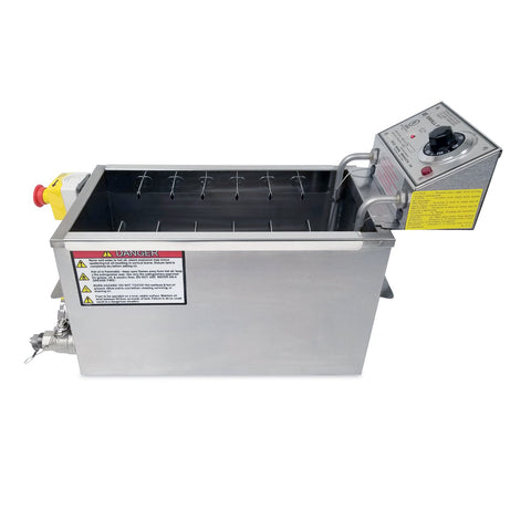 Right side of stainless steel fryer, deep narrow rectangle oil tank. Control panel rear mounted above oil tank with skewer clips inside tank. Warning label on right side.