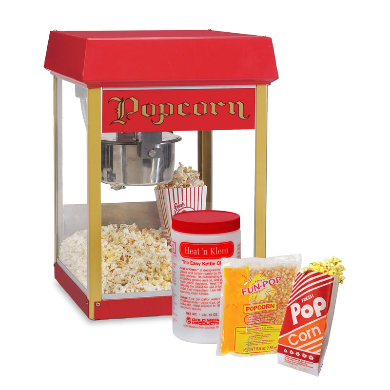 Four ounce Fun Pop Popcorn Machine with red top and popcorn sign, container of heat and clean kettle cleaner, corn oil salt mega pop popcorn kits and popcorn bags.