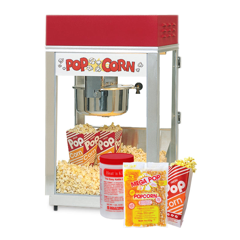 Six ounce popcorn machine with red top and popcorn sign, container of heat and clean kettle cleaner, corn oil salt mega pop popcorn kits and popcorn bags.